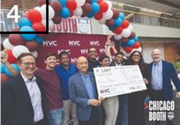Students Holding a Giant Check at NVC Event